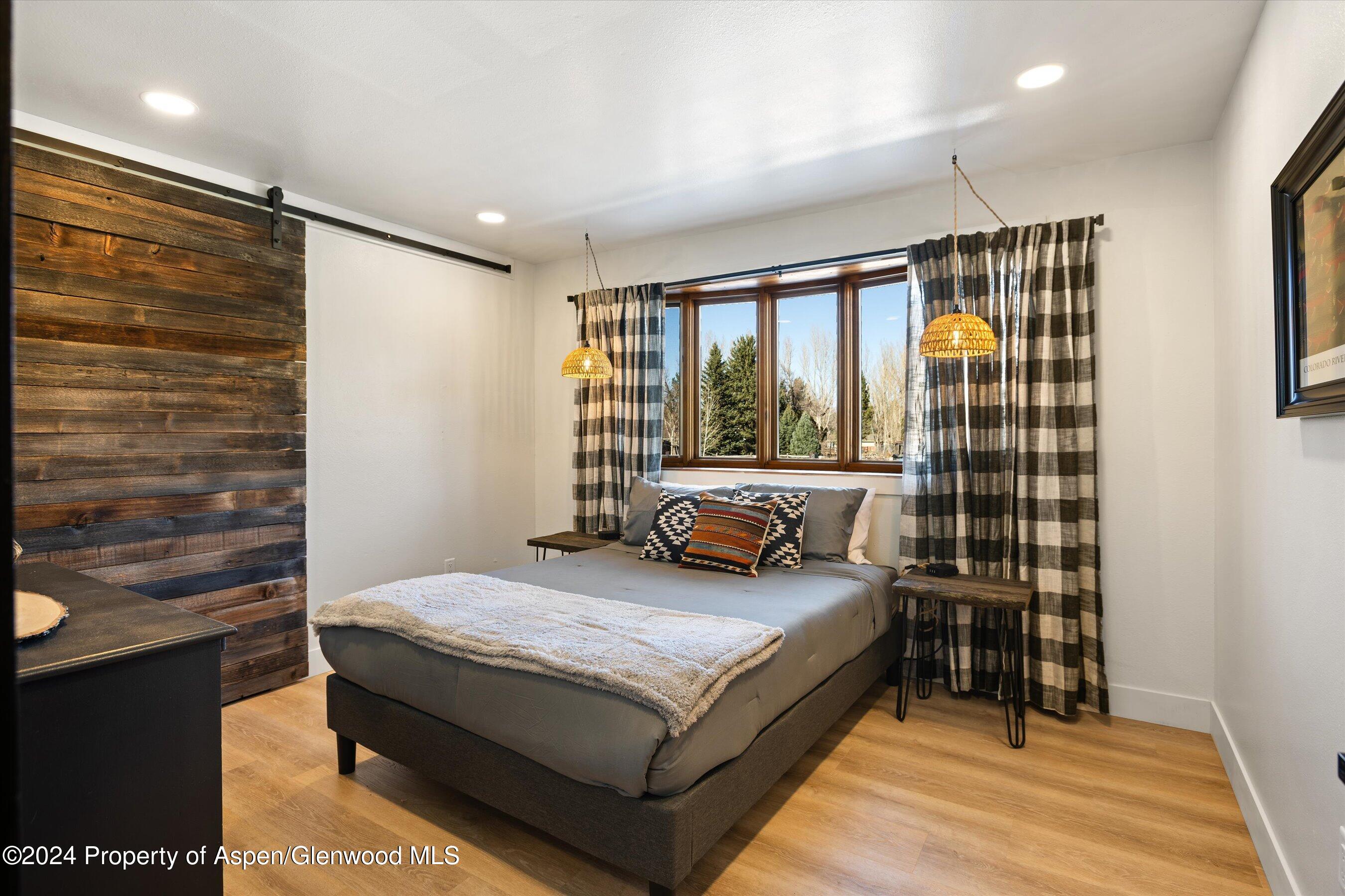 24 Cherry Lane Basalt, CO 81621 - Photo 15 of 42 a bedroom with a bed and wooden floor