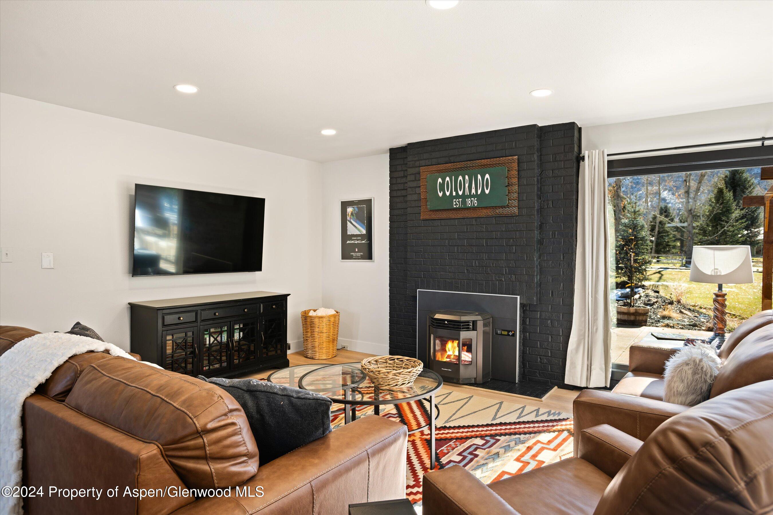 24 Cherry Lane Basalt, CO 81621 - Photo 5 of 42 a living room with furniture a flat screen tv and a fireplace