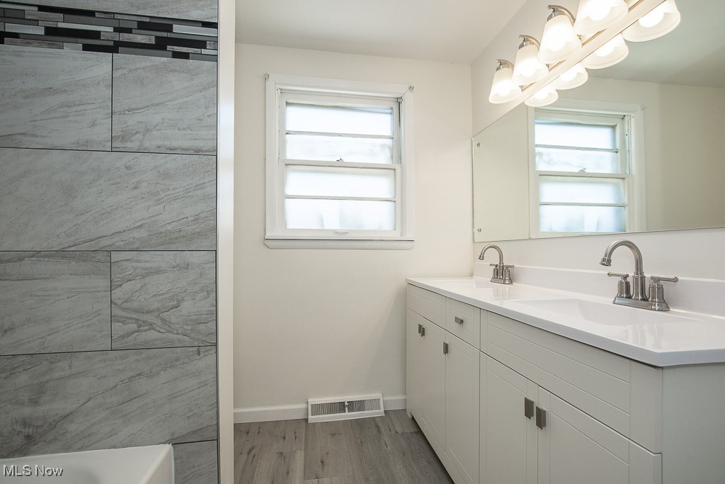 3136 Becket Road Cleveland, OH 44120 - Photo 6 of 39 Bathroom featuring hardwood / wood-style floors, vanity, and a bathtub