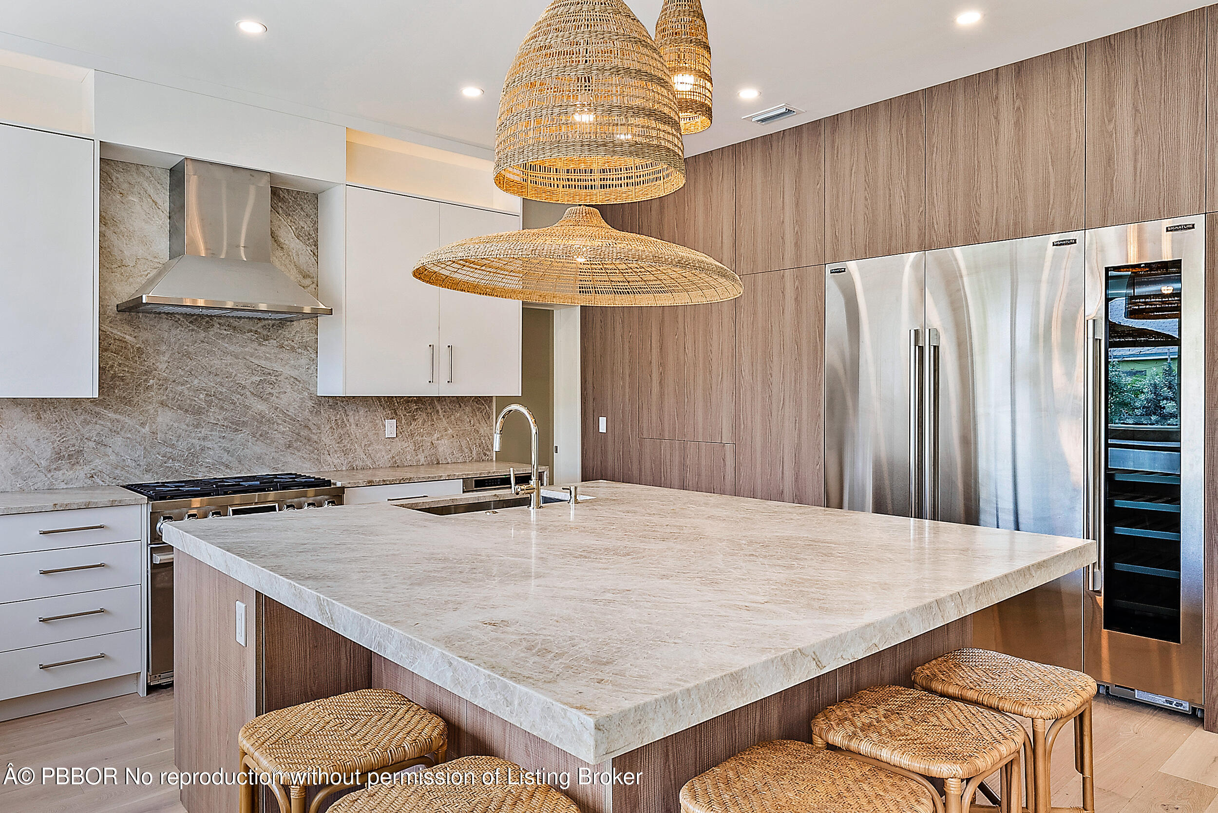 310 Edmor Road West Palm Beach, FL 33405 - Photo 11 of 32 a kitchen with stainless steel appliances a table chairs and a refrigerator