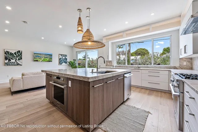 a kitchen with stainless steel appliances a sink and a stove