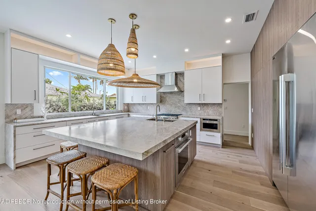 a kitchen with a stove a refrigerator and a sink