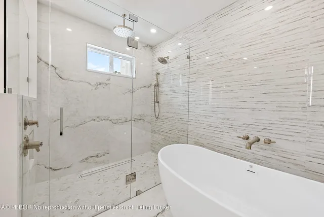 a bathroom with a bathtub and shower