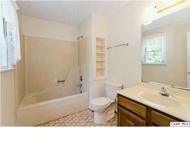 4750 Mechunk Road Keswick, VA 22947 - Photo 12 of 23 a bathroom with a sink a toilet a shower and a mirror