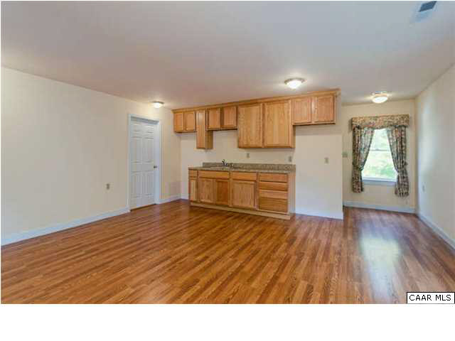 4750 Mechunk Road Keswick, VA 22947 - Photo 18 of 23 a room with kitchen island wooden floors appliances and cabinets
