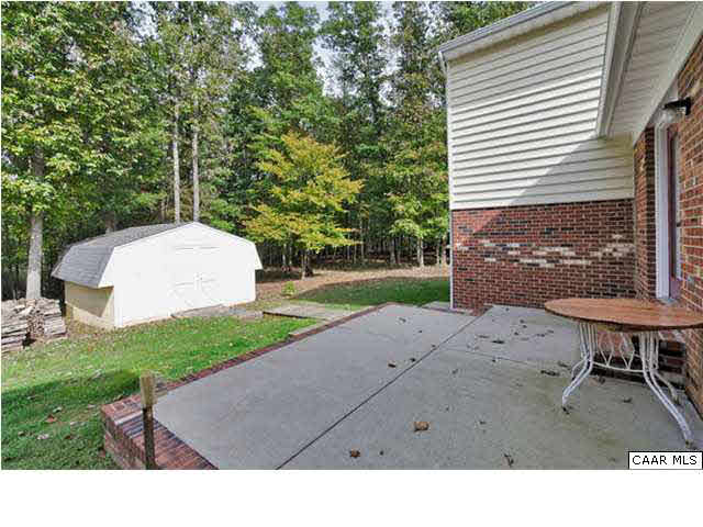 4750 Mechunk Road Keswick, VA 22947 - Photo 21 of 23 a backyard of a house with table and chairs