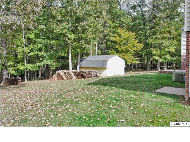 4750 Mechunk Road Keswick, VA 22947 - Photo 22 of 23 a view of a backyard with a garden and trees