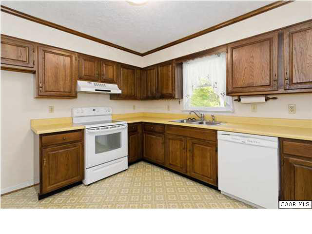 4750 Mechunk Road Keswick, VA 22947 - Photo 6 of 23 a kitchen with stainless steel appliances granite countertop a sink a stove a refrigerator with grey cabinets