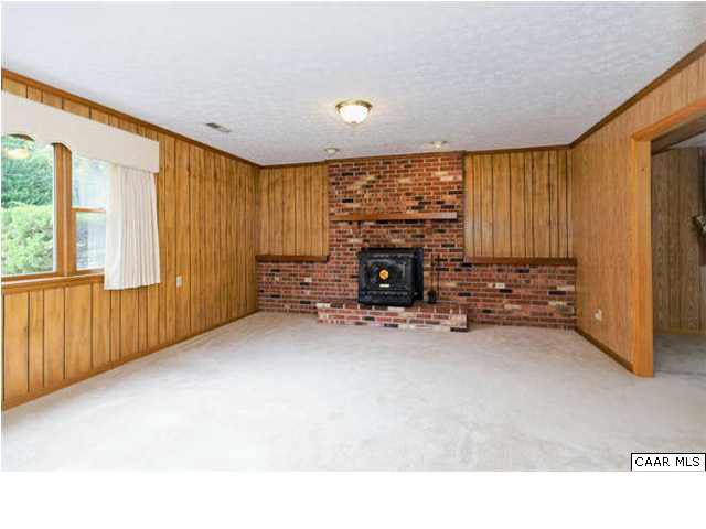4750 Mechunk Road Keswick, VA 22947 - Photo 9 of 23 a view of empty room with fireplace and windows