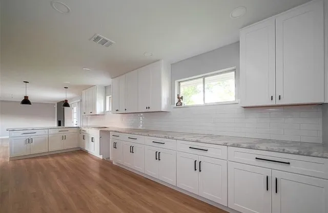 a kitchen with sink cabinets and window