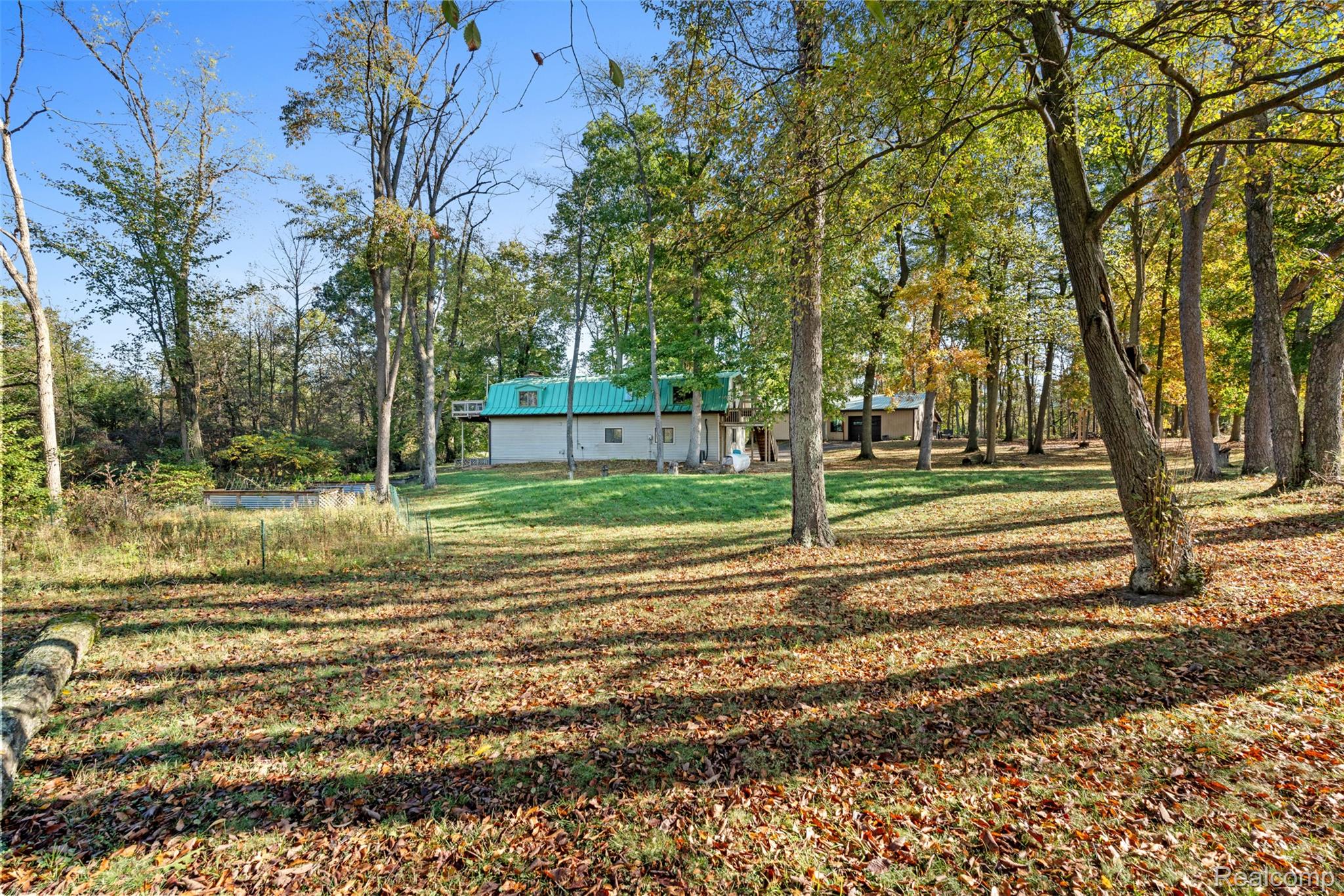 7670 Mi State Road Manchester, MI 48158 - Photo 36 of 53 View of grassy yard featuring view of wooded area