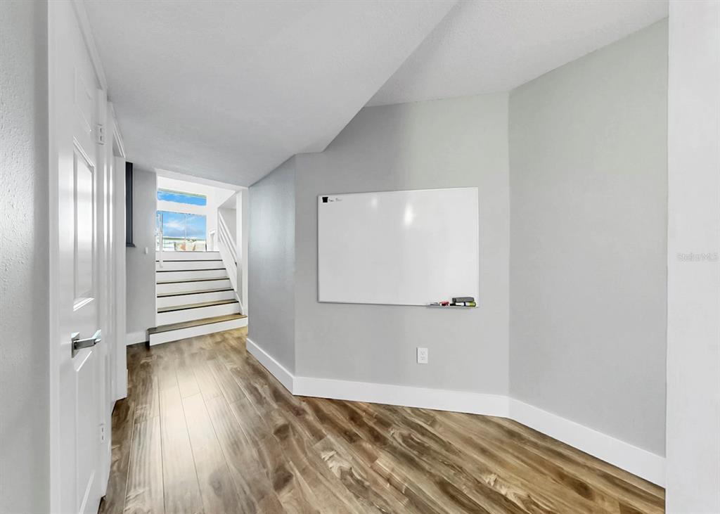 6504 Surfside Boulevard, Unit 4 Apollo Beach, FL 33572 - Photo 16 of 41 a view of a room with wooden floor and staircase