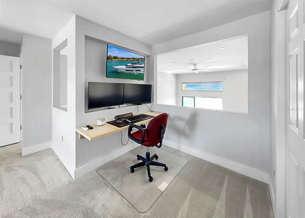 6504 Surfside Boulevard, Unit 4 Apollo Beach, FL 33572 - Photo 26 of 41 a view of a livingroom with workspace and a window