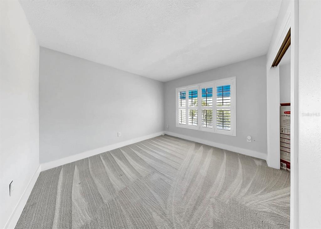 6504 Surfside Boulevard, Unit 4 Apollo Beach, FL 33572 - Photo 33 of 41 a view of an empty room with wooden floor and a window