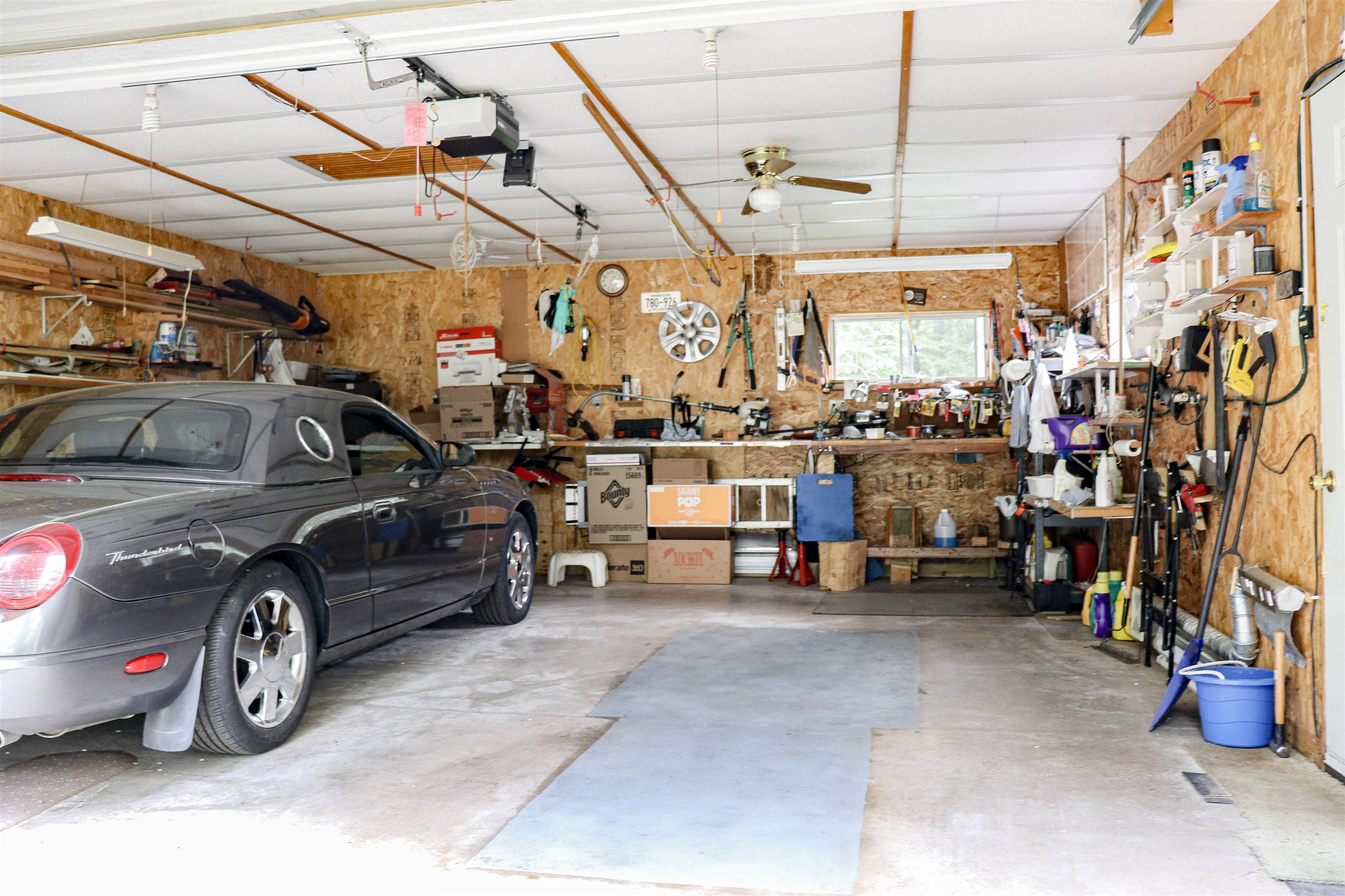 4950 Midway Road Duluth, MN 55811 - Photo 11 of 26 Garage featuring a workshop area, a garage door opener, and a ceiling fan