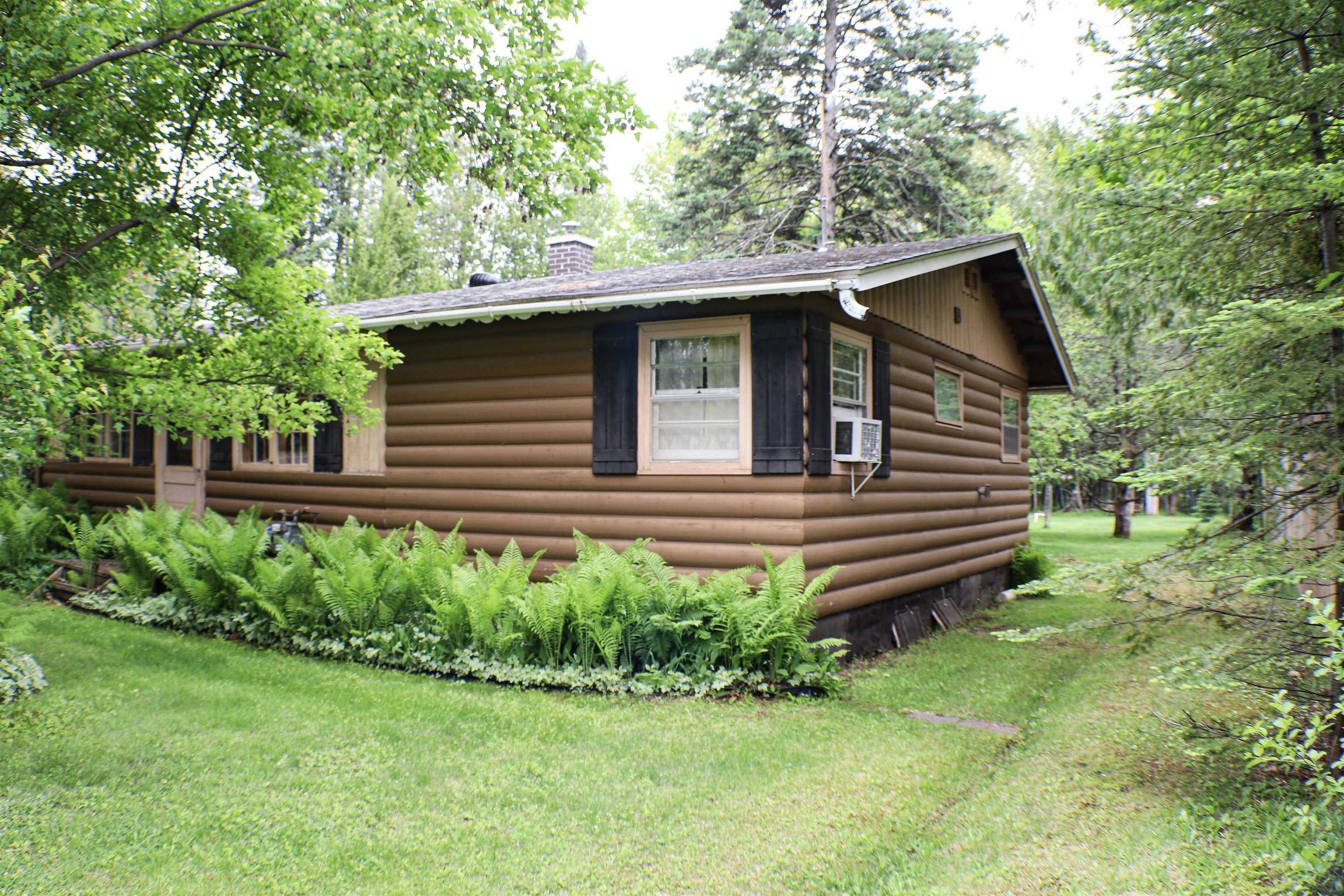 4950 Midway Road Duluth, MN 55811 - Photo 2 of 26 View of property exterior with a chimney, a yard, and cooling unit