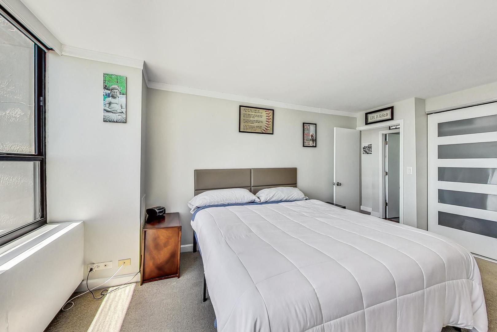 655 West Irving Park Road, Unit 5503 Chicago, IL 60613 - Photo 14 of 32 a bedroom with a bed and a window