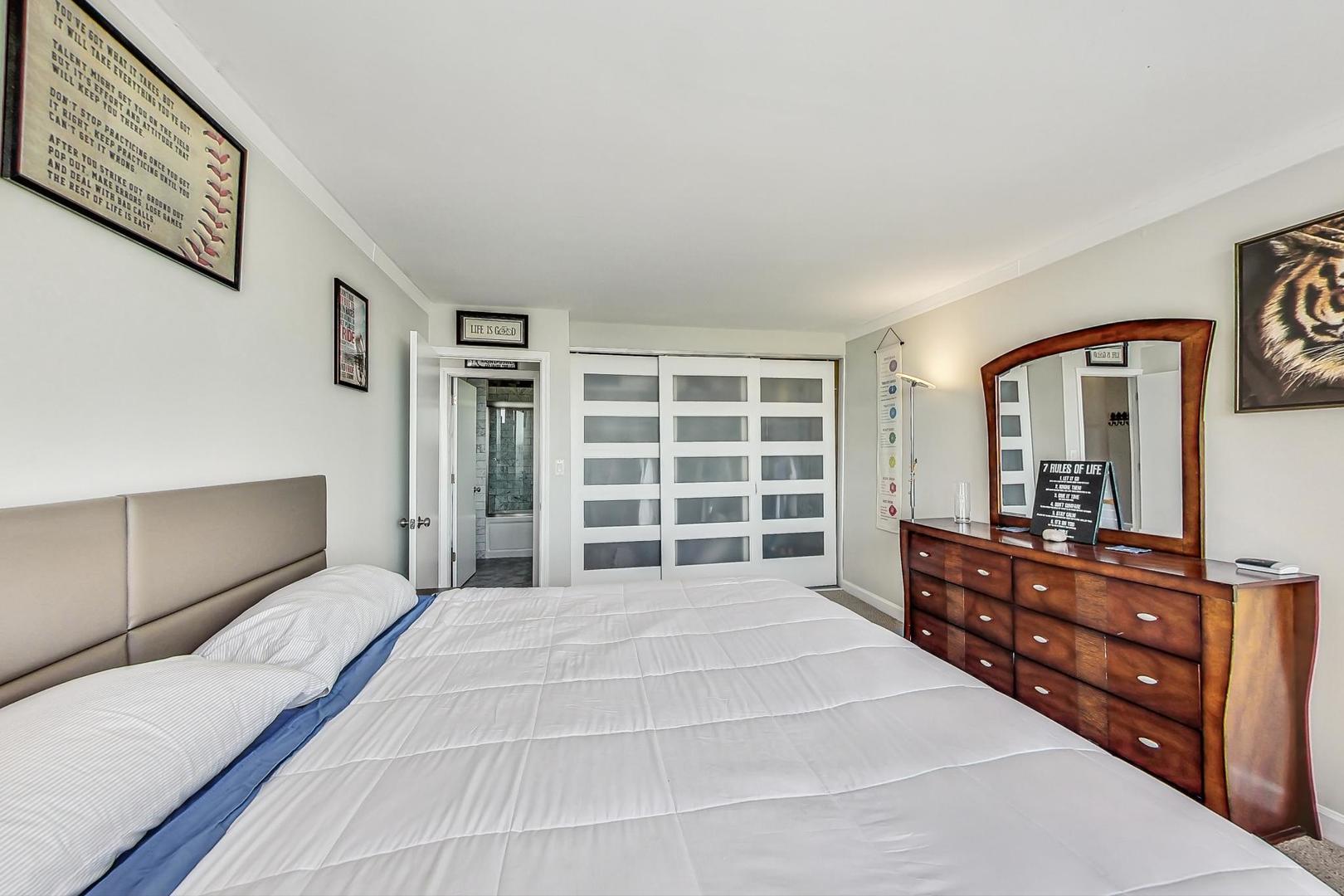 655 West Irving Park Road, Unit 5503 Chicago, IL 60613 - Photo 15 of 32 a spacious bedroom with a bed and a dresser