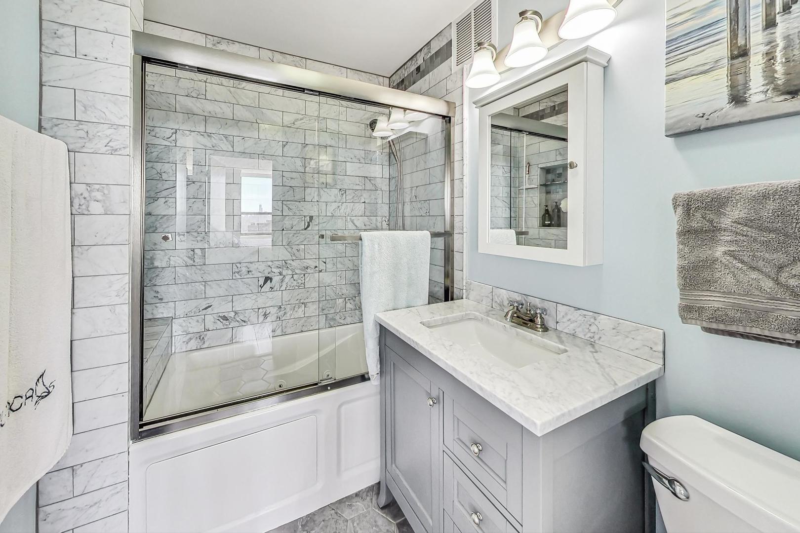 655 West Irving Park Road, Unit 5503 Chicago, IL 60613 - Photo 16 of 32 a bathroom with a sink toilet vanity and shower
