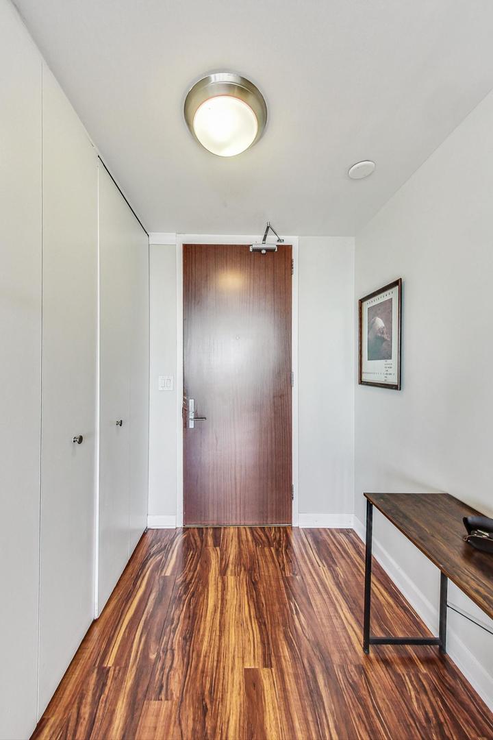 655 West Irving Park Road, Unit 5503 Chicago, IL 60613 - Photo 17 of 32 a view of a livingroom with wooden floor