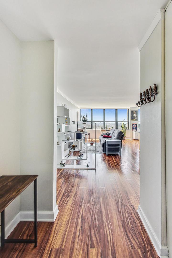 655 West Irving Park Road, Unit 5503 Chicago, IL 60613 - Photo 18 of 32 a living room with furniture and wooden floor
