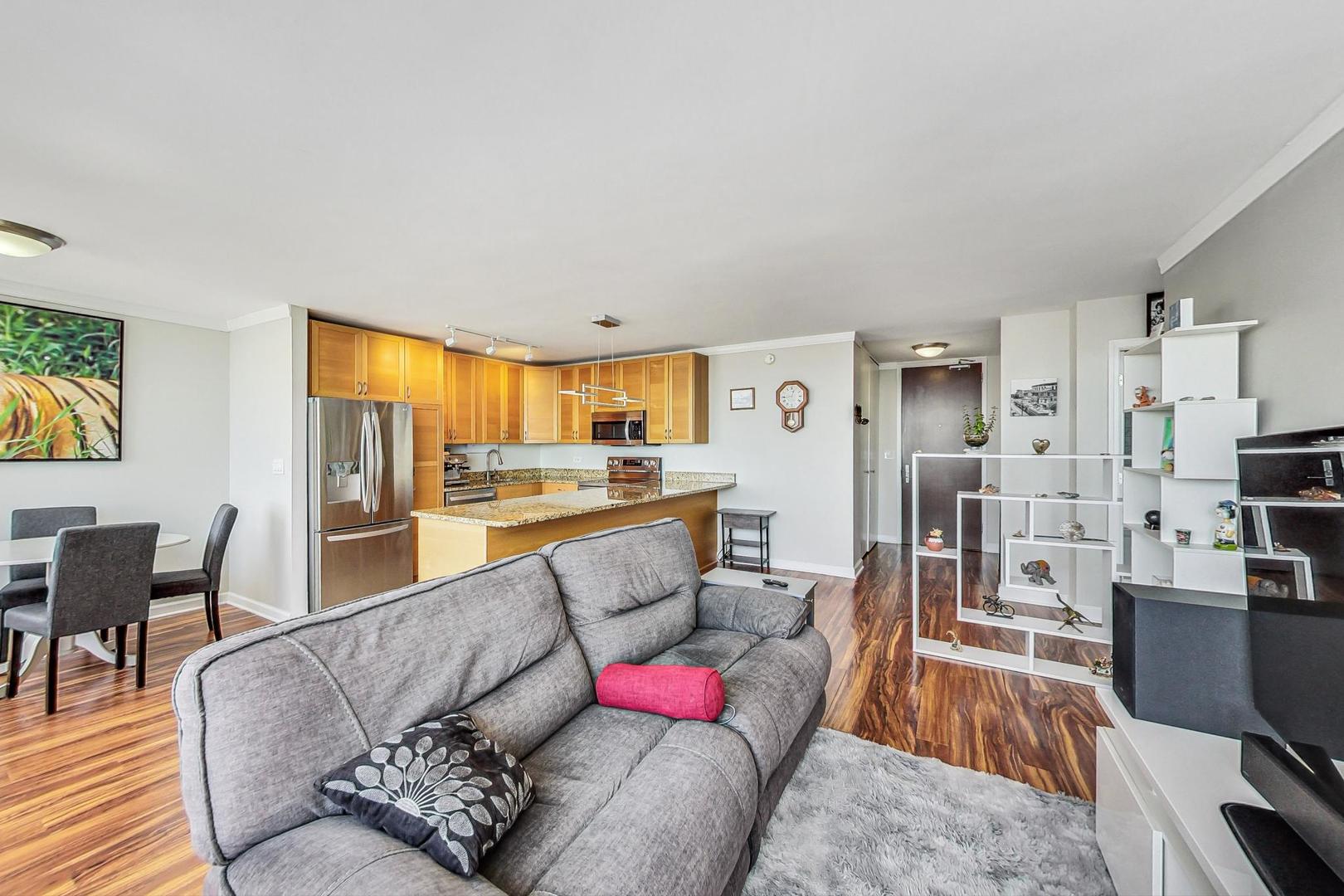 655 West Irving Park Road, Unit 5503 Chicago, IL 60613 - Photo 4 of 32 a living room with furniture and view of kitchen