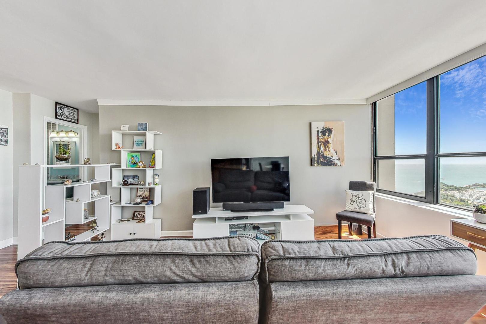655 West Irving Park Road, Unit 5503 Chicago, IL 60613 - Photo 5 of 32 a living room with furniture and a flat screen tv