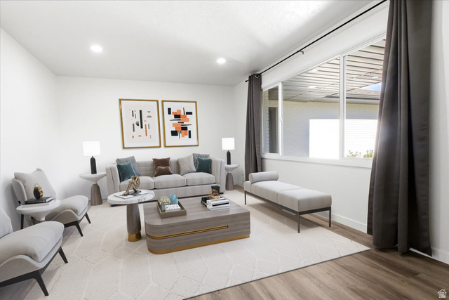 1676 East 11245 South Sandy, UT 84092 - Photo 10 of 34 Spacious living area featuring recessed lighting, a large window, and wood-finish flooring. This photo is virtually staged.
