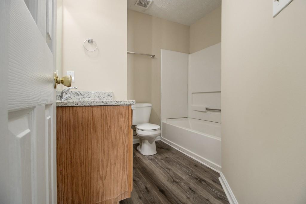 6510 Charter Way Lithonia, GA 30058 - Photo 19 of 27 a bathroom with a granite countertop toilet sink and shower