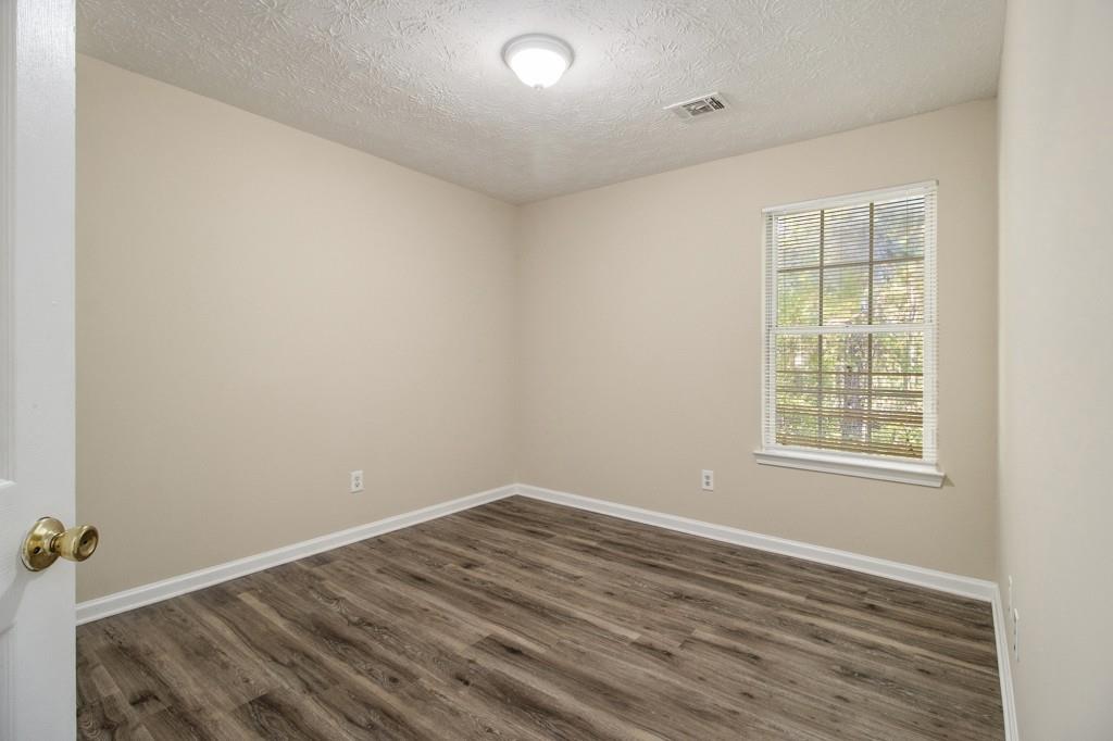 6510 Charter Way Lithonia, GA 30058 - Photo 20 of 27 an empty room with wooden floor and windows