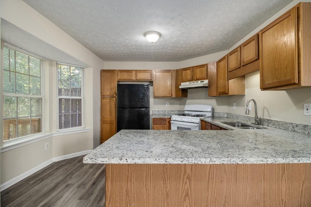 6510 Charter Way Lithonia, GA 30058 - Photo 3 of 27 a kitchen with granite countertop a sink a counter space appliances and cabinets