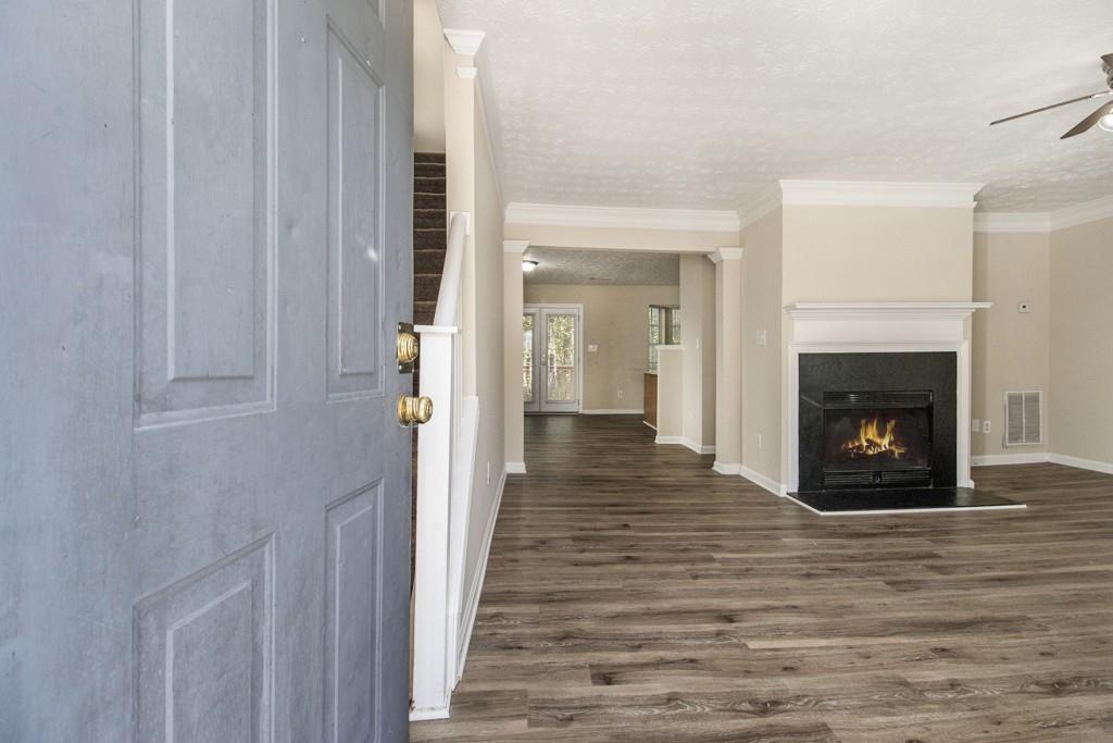 6510 Charter Way Lithonia, GA 30058 - Photo 5 of 27 a view of a livingroom with wooden floor and a fireplace