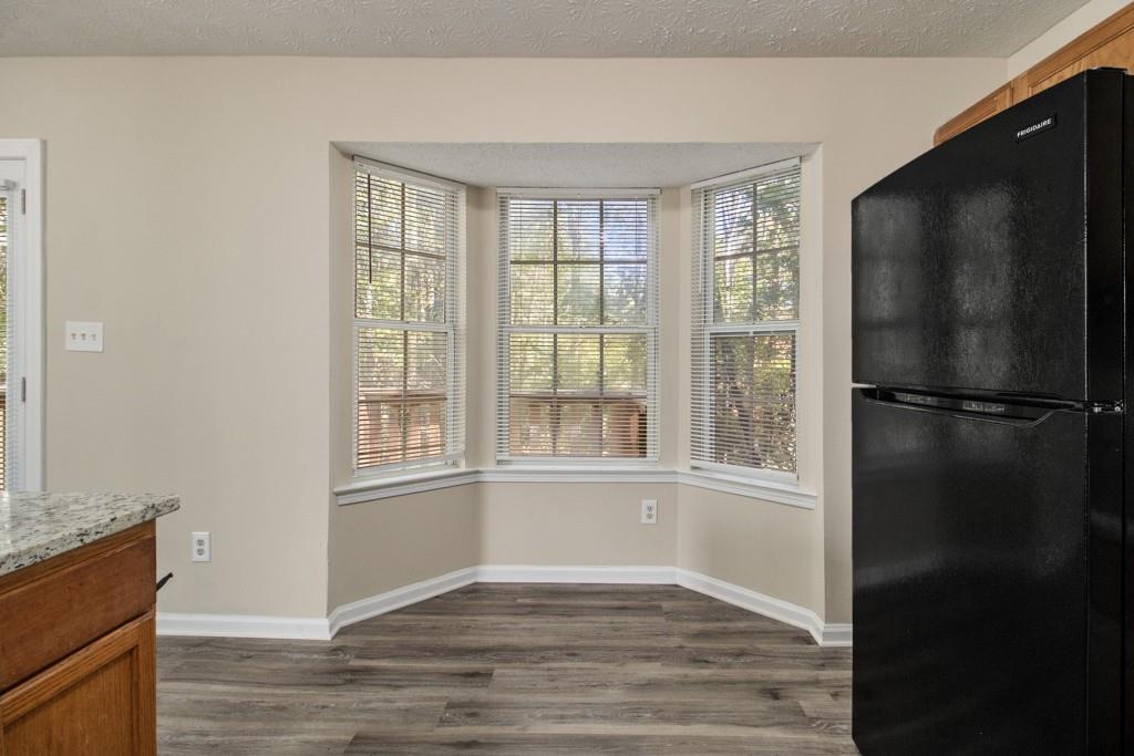 6510 Charter Way Lithonia, GA 30058 - Photo 10 of 27 a view of an empty room with wooden floor and a window