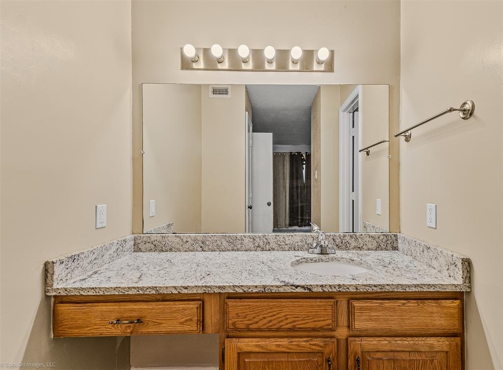 925 Signal Ridge Place Rockwall, TX 75032 - Photo 11 of 21 a bathroom with a granite countertop sink and a mirror