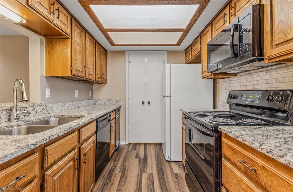 925 Signal Ridge Place Rockwall, TX 75032 - Photo 2 of 21 a kitchen with stainless steel appliances granite countertop a stove and a sink