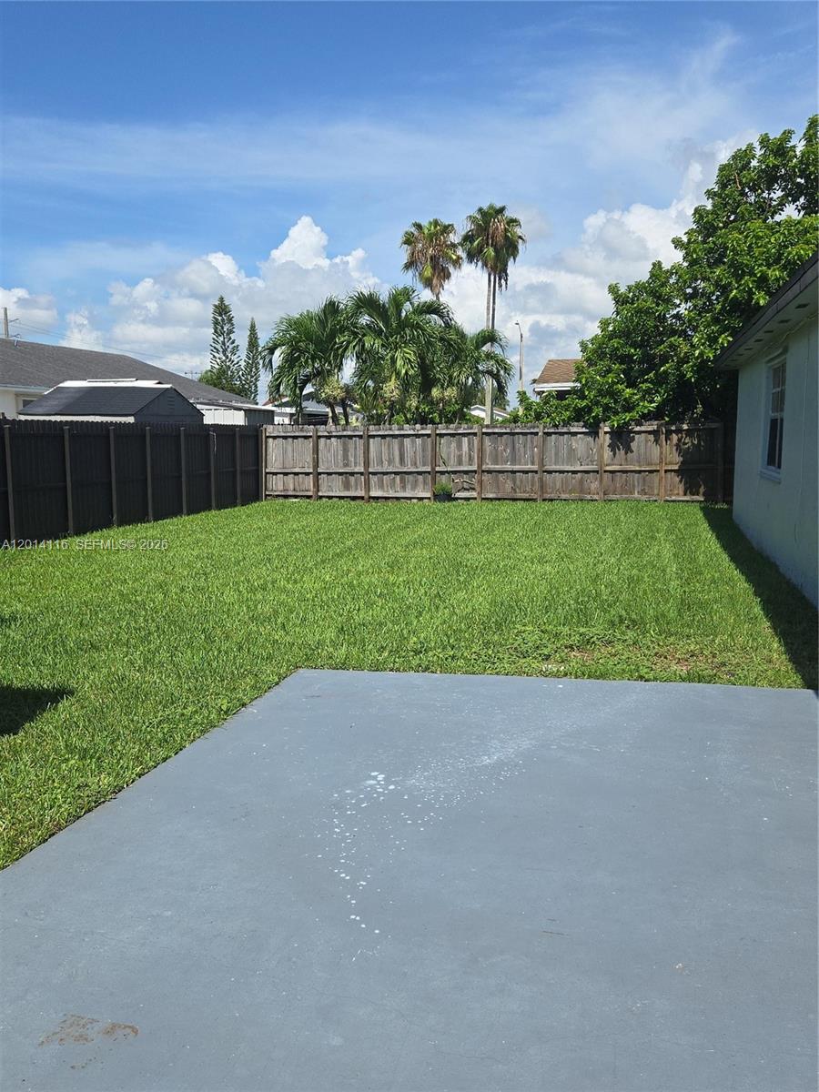 12328 Southwest 259th Street Homestead, FL 33032 - Photo 15 of 18 a view of a garden with a building in the background