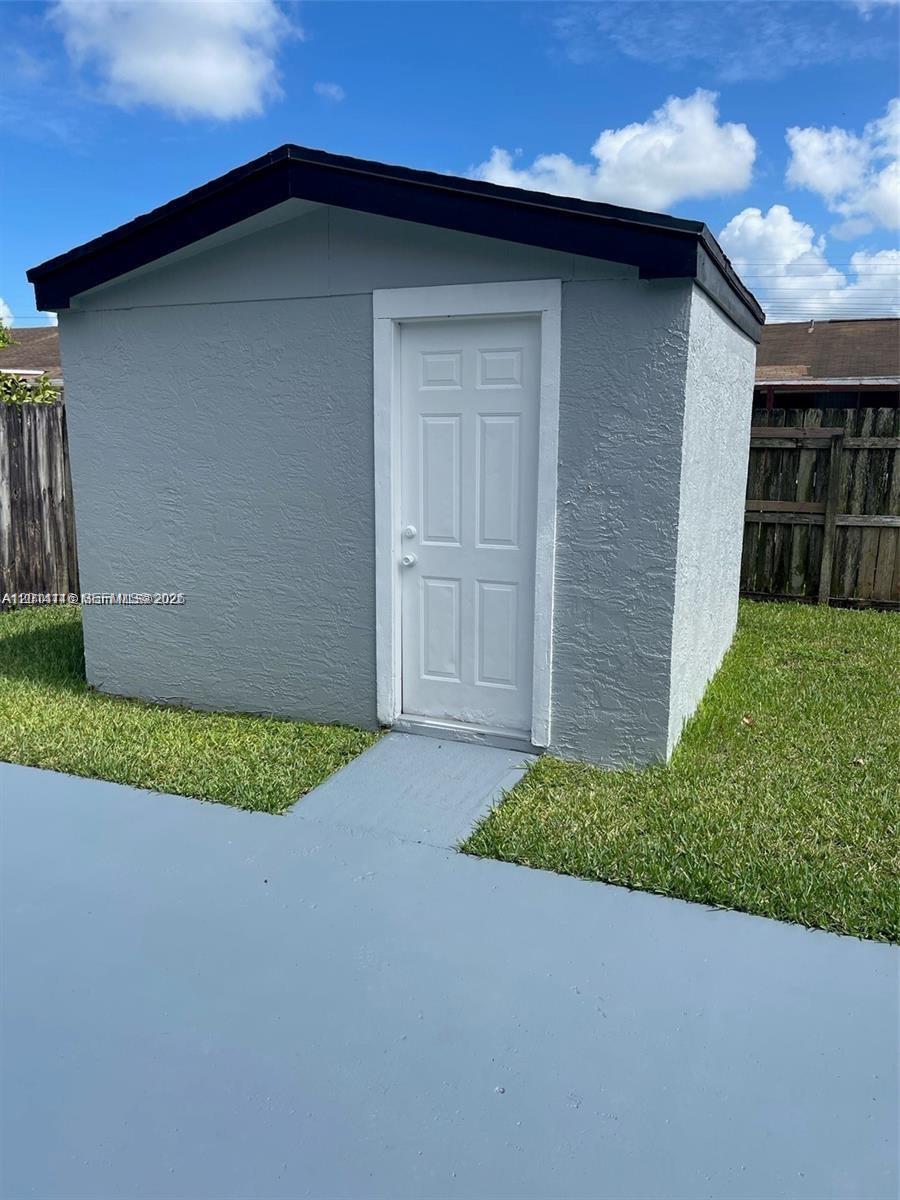 12328 Southwest 259th Street Homestead, FL 33032 - Photo 16 of 18 a backyard of a house with lots of green space