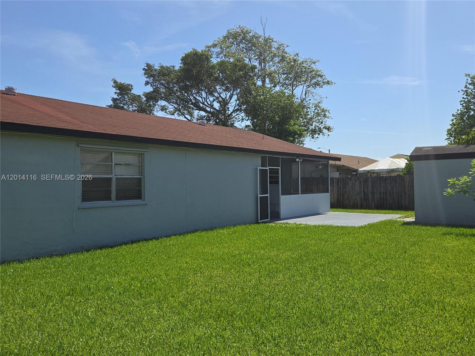 12328 Southwest 259th Street Homestead, FL 33032 - Photo 17 of 18 a backyard of a house with lots of green space