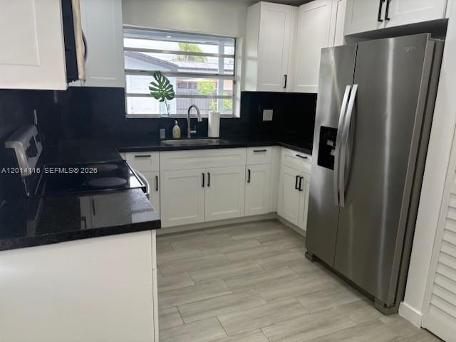 12328 Southwest 259th Street Homestead, FL 33032 - Photo 2 of 18 a kitchen with stainless steel appliances a refrigerator and a stove