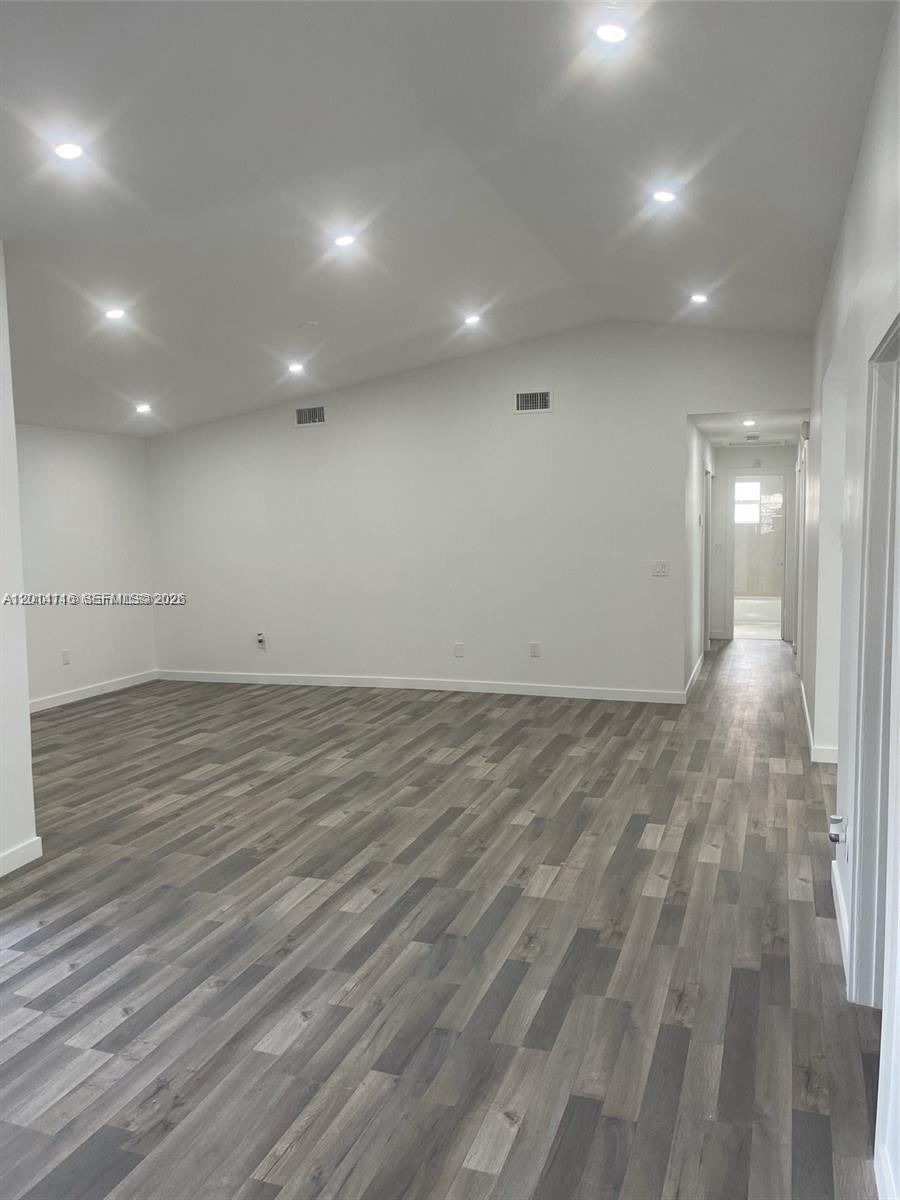 12328 Southwest 259th Street Homestead, FL 33032 - Photo 4 of 18 an empty room with wooden floor and windows
