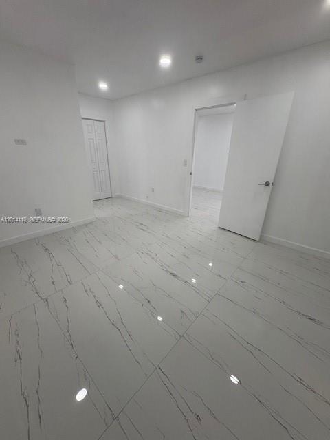 12328 Southwest 259th Street Homestead, FL 33032 - Photo 5 of 18 an empty room with white walls and tiles