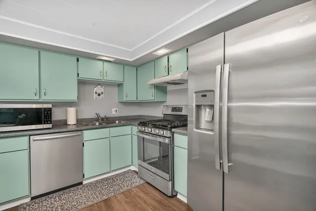 a kitchen with cabinets and stainless steel appliances