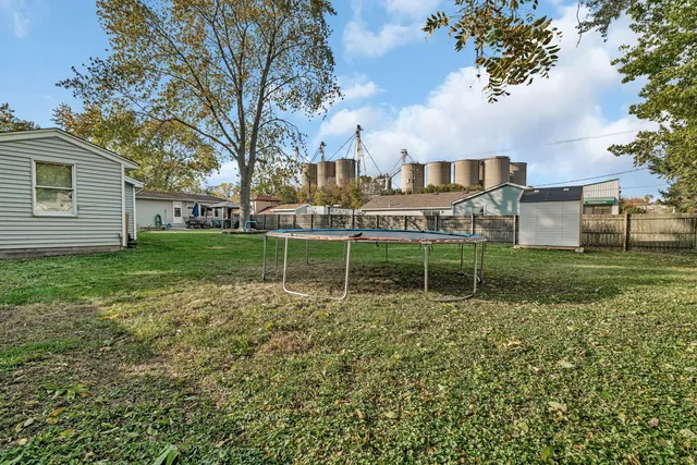 a backyard of a house with table and chairs