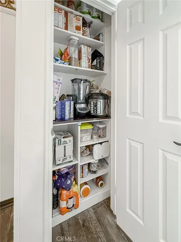 a view of staircase with wooden floor and white walls