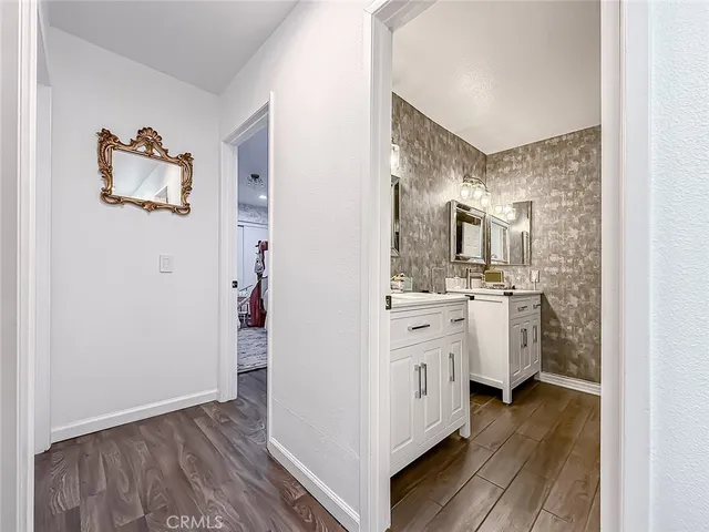 a bathroom with a sink a toilet a mirror and vanity