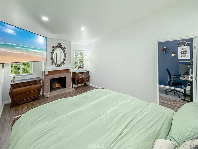 a bedroom with a bed a couch and a large window