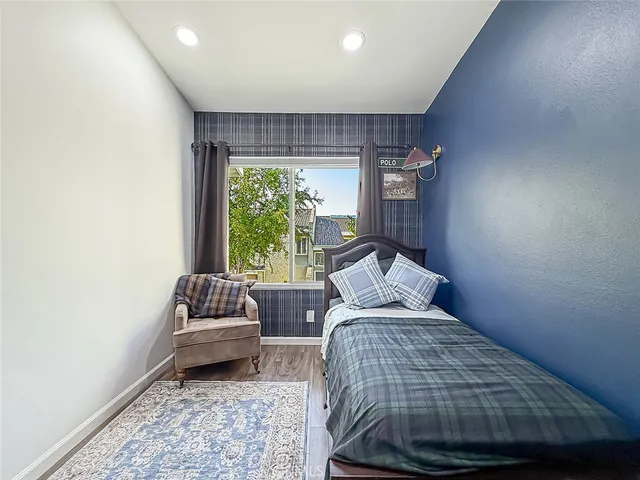 a bed sitting in a bedroom next to a window