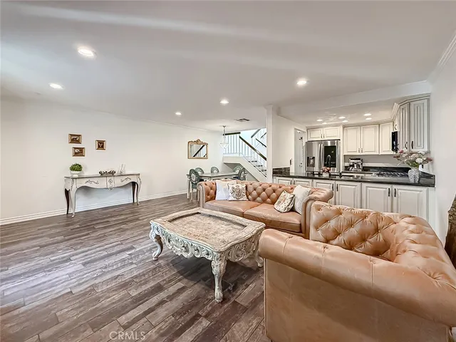a living room with furniture and kitchen view