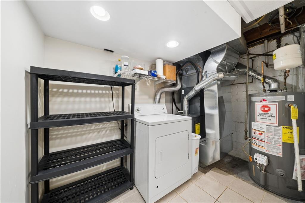 711 Jane Street Pittsburgh, PA 15239 - Photo 19 of 27 Functional laundry and utility room complete with built-in storage shelving and direct mechanical access.