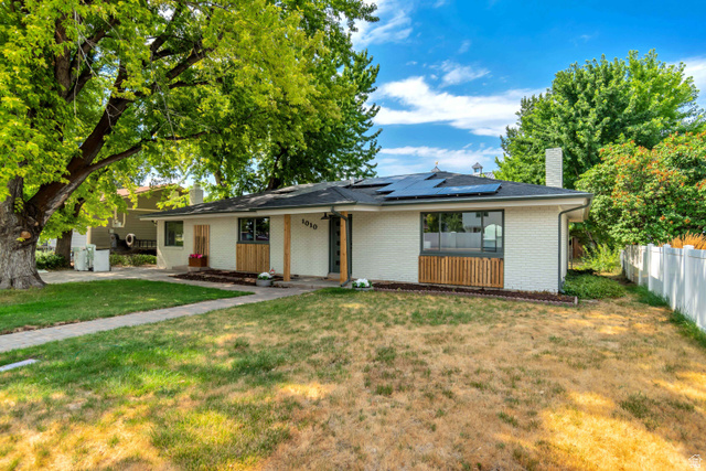 1010 West Maple Street Mapleton, UT 84664 - Photo 24 of 24 White brick residence with a dark roof and solar panels